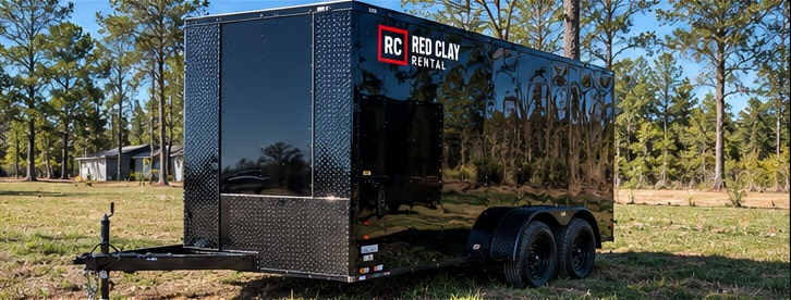 Black enclosed cargo trailer with Red Clay Rental concept branding